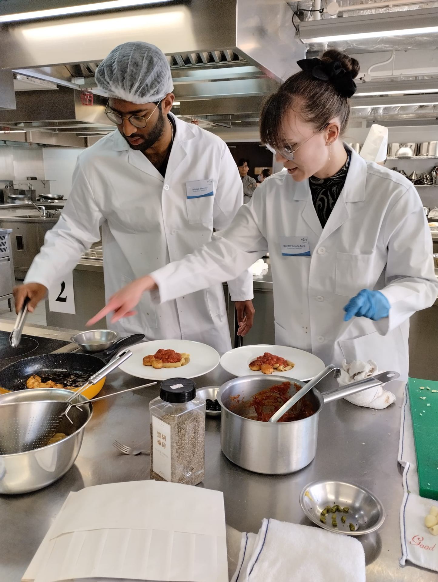 Culinary competition — plating pasta with a hospitality student